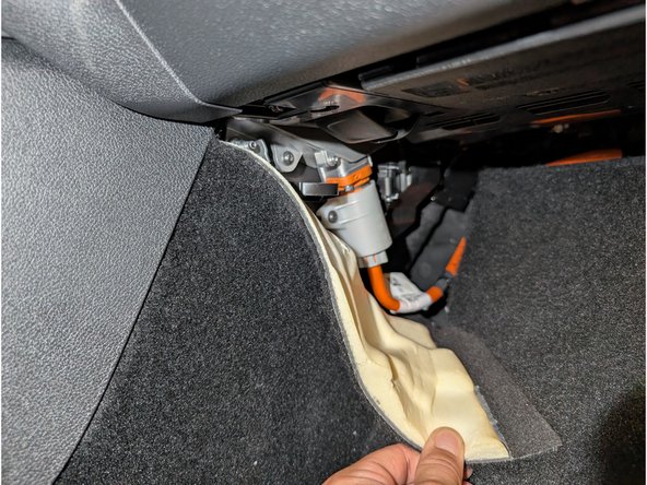 Pull the footwell carpet gently aside until the passenger fusebox is exposed.
