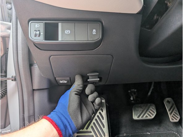 Unclip and remove the panel from the side of the dashboard.