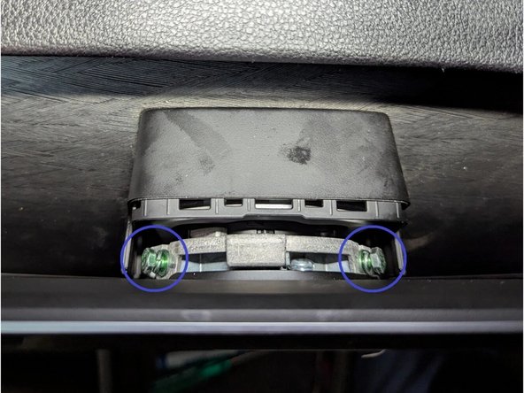 Rotate the infotainment display to detach it from the metal bracket.