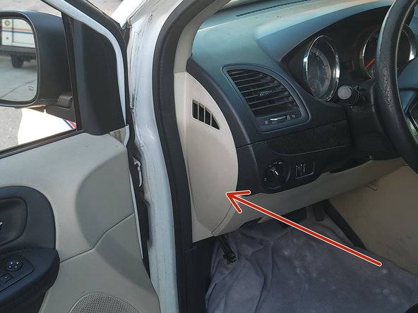 Using a panel removal tool, remove the dashboard side trim panel.