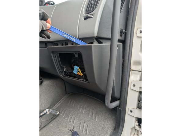 Use a panel removal tool to detach the middle interior panel.