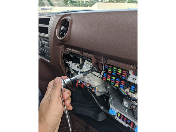 Remove the upper passenger-side dash panel by removing the two 10 mm bolts.