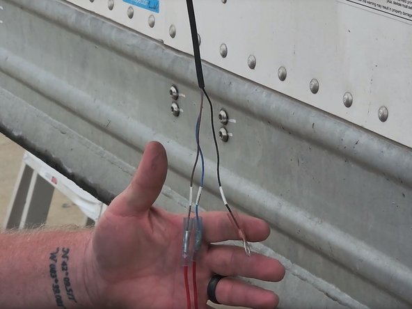 Install fuse holders on the blue and brown wires, and then install the ring connector on the black wire.