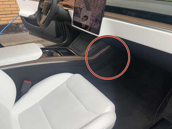 Unclip and remove the carpet and panel in the passenger footwell.