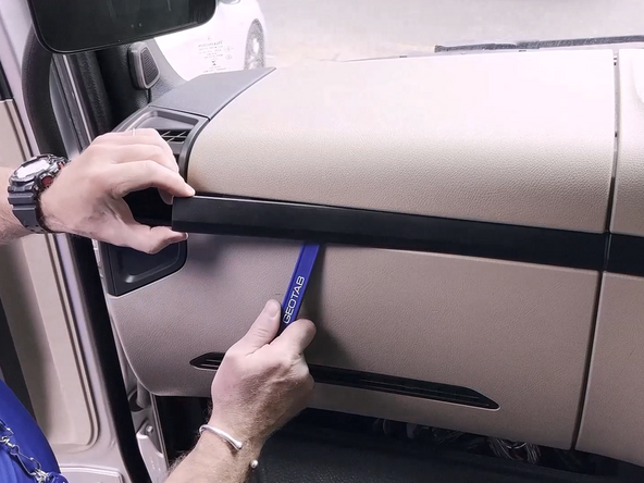 Remove the plastic trim using a panel removal tool.
