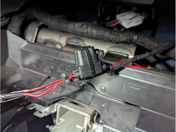 Secure the remaining length of the harness with cable ties as shown.