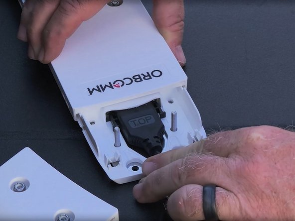 Next, plug the harness into the device and put the cover back on.