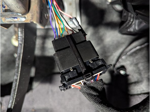 Connect the female end of the HRN-GS16K22-A harness to the factory diagnostics port and secure it with a cable tie as shown.