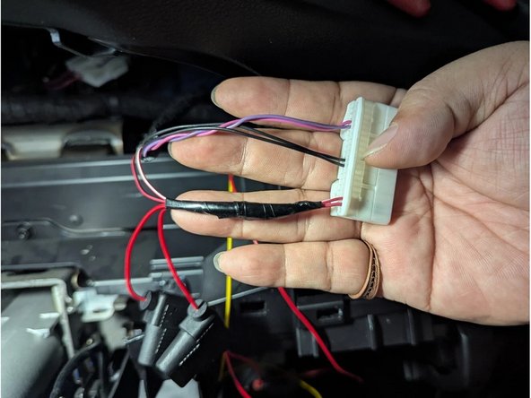 Secure the remaining length of the harness with cable ties as shown.