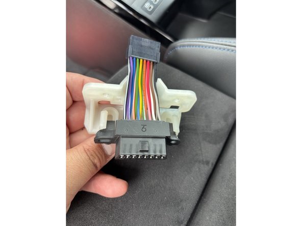 The harness female socket will now be accessible — this will be used to reconnect the factory OBD2 connector if needed.