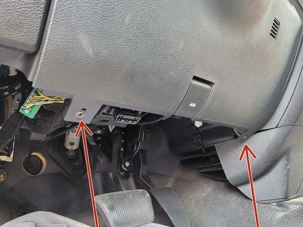 Remove (2) 7mm screws from the bottom of the knee bolster panel.