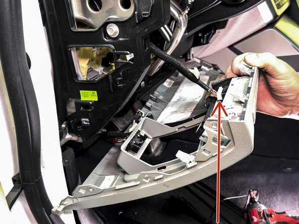 Using a panel removal tool, release the knee bolster and unplug this connector.