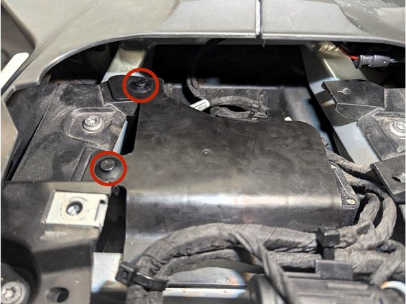 Remove the 2 x expanding rivets using a flat screwdriver or an appropriate removal tool then pull the cover outwards.