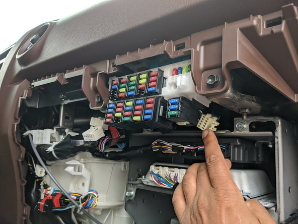 Locate the 10-pin GPS connector at the back right of the fuse box