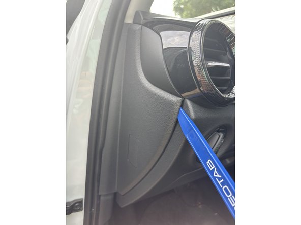 Pull the middle panel on the A-pillar using a panel removal tool.