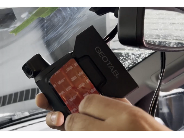 Remove the red adhesive backing from the mounting bracket on the back of the camera.