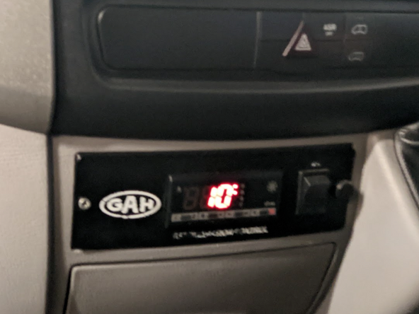 Locate the refrigeration unit controller inside the cab of the vehicle.