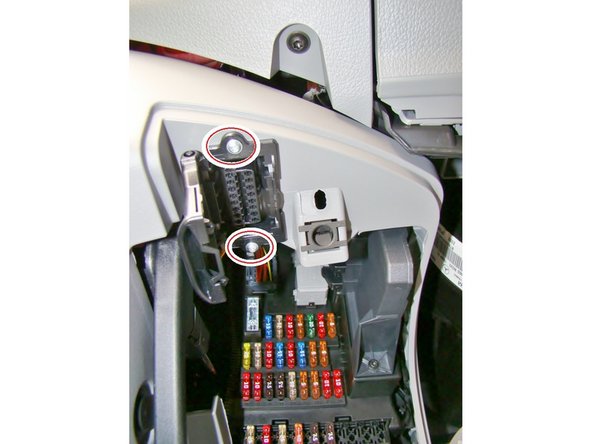 Use a size T20 Torx-driver to remove the two screws and carefully unclip and remove the OBD-Port.
