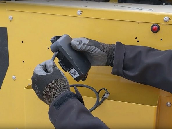 To route the harness  out of the side, remove the plastic cover to reposition the harness.