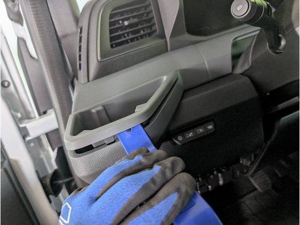 Use a flat panel removal tool to remove the  driver side cupholder panel.