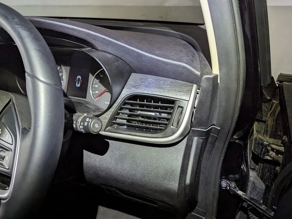 Remove the side air vent using a flat-bladed screwdriver or plastic pry tool.