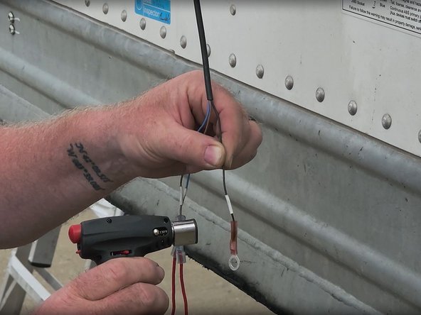 Install fuse holders on the blue and brown wires, and then install the ring connector on the black wire.