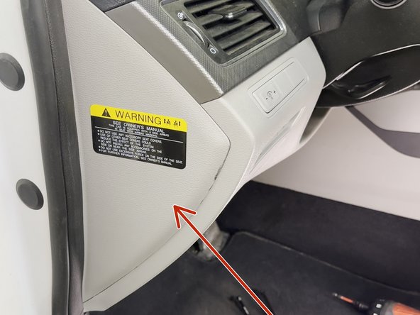 Using a panel removal tool, remove the side dash access panel.