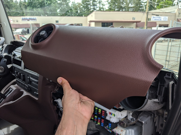 Remove the upper passenger-side dash panel by removing the two 10 mm bolts.