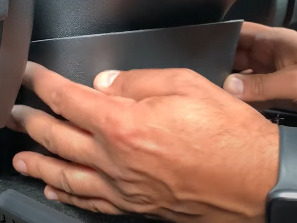 Reinstall the center panel by lining up clips and firmly pressing into place.