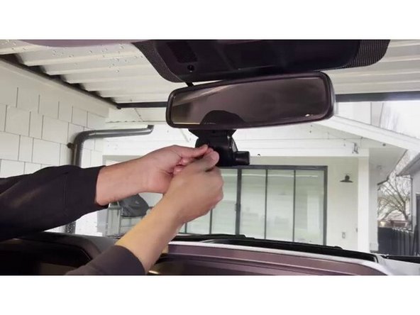 Route the aux camera cable from the GO Focus Plus along the vehicle headliner toward the rear window. Tuck the cable behind trim panels and headliner edges where possible to keep the installation clean.