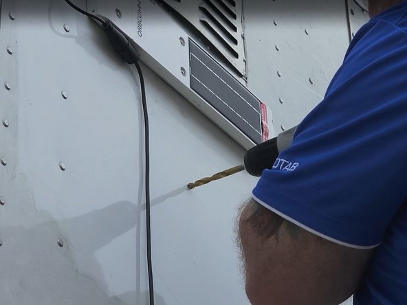 Drill a hole for the harness to pass through and install a grommet in the hole.