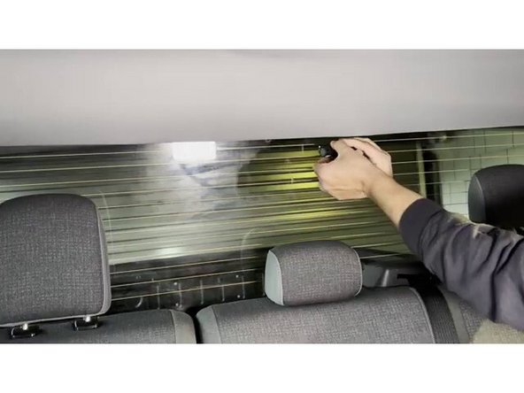 Remove the red adhesive backing from the aux camera mounting bracket. Plug the aux camera cable into the camera before pressing it to the glass.