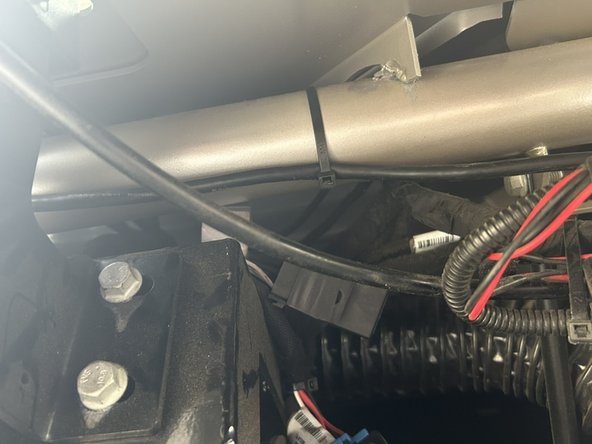 Since there is a lot of GPS and cellular interference on the drivers side, route the extension cable toward the middle of the dashboard securing along the brace as shown to ensure it stays clear of drivers feet, and the steering wheel tilt mechanism.