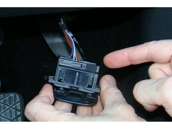 This is done by sliding open the clip at the back of the mounting bracket