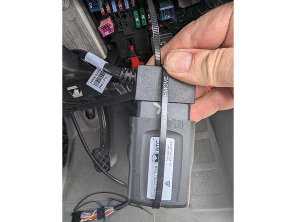 Plug the Geotab device into the harness, and secure with a cable tie as shown