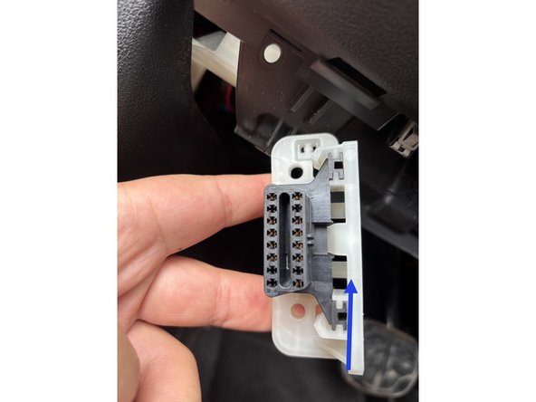Press the clip that hold the OBD to the bracket in order to releas it.