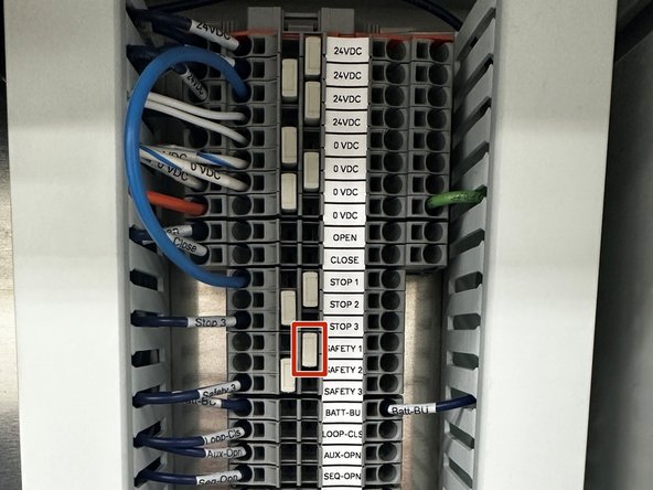 REMOVE FACTORY JUMPER WIRE BETWEEN 24VDC AND SAFETY1 + REMOVE THE GRAY TERMINAL BLOCK JUMPER BAR BETWEEN SAFETY 1 AND SAFETY 2