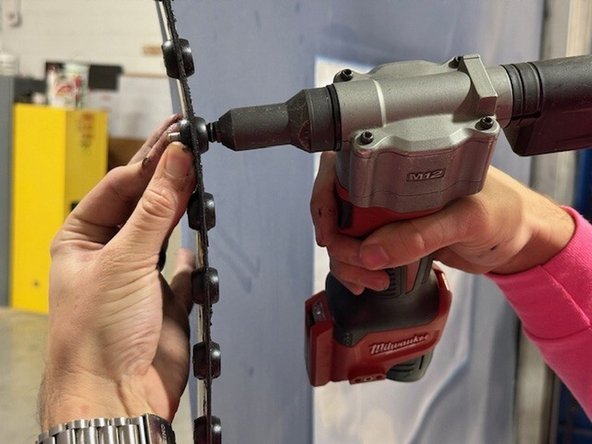 Place your rivet gun/tool onto the rivet