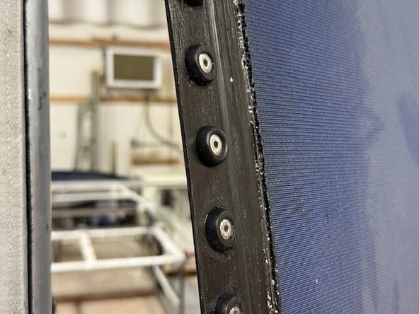 Install the curtain tag onto the rivet from the opposite (front) side of the curtain.