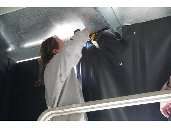 The Top Face Curtain will be installed at the top of the rear face of the gutter by drilling the provided Self-Tapping Screws through the grommets in the top of the Curtain and into the pilot holes on the rear face of the gutter.