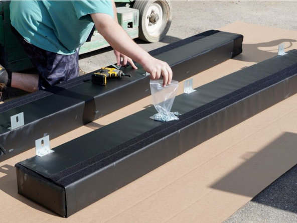 Using the provided Hex Head Screws, attach Angle Brackets on the inside and outside edges of the side pads. There will be one bracket 8&quot;-12&quot; from the top and bottom edges, and one centered as shown.