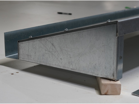 Once the Left Side Gusset is aligned properly, secure it by fastening the (3) provided self-tapping screws through the Roof Panel into the Gusset.