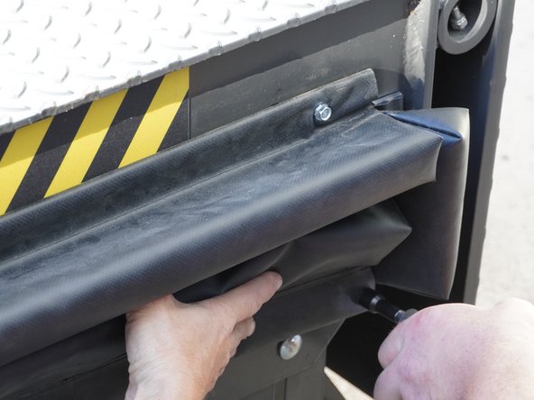 Orient the Lower Seal (76" Long) on the side of the Dock Leveler with the Aluminum Bar Stock below the foam portion of the Seal.