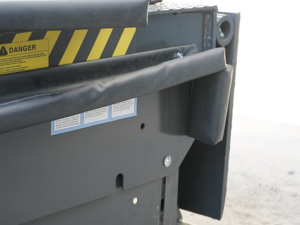 Using the provided Self-Tapping Screws and a Torque Driver, screw through the Aluminum Bar Stock into the side of the Dock Leveler 1" in from each end of the Front Seal.