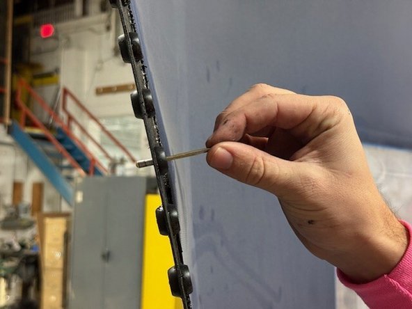 Place one curtain tag onto the rivet and stage it in the hole in the plastic edge material (on the curtain).