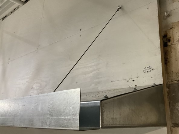 Secure the other side of the aircraft cable  using best practices for your surface material to anchor the cable to the mounting surface.