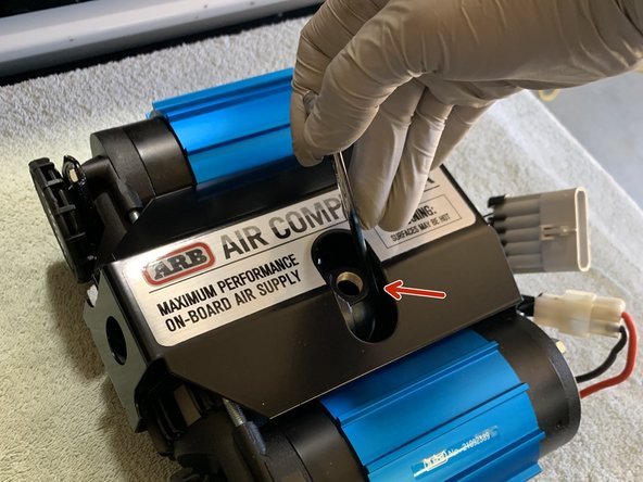 To optimize air line route, loosen manifold cap with 10mm box end wrench  and rotate housing 15deg. Once adjusted, tighten manifold cap to approximately 7 lb-ft (9 Nm)