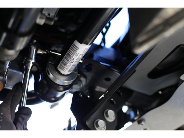 Re-install the front bumper on the vehicle. Make sure the bumper is fully seated against the mounting plates on the frame, and loosely install a couple of the factory nuts so that the bumper cannot come off.