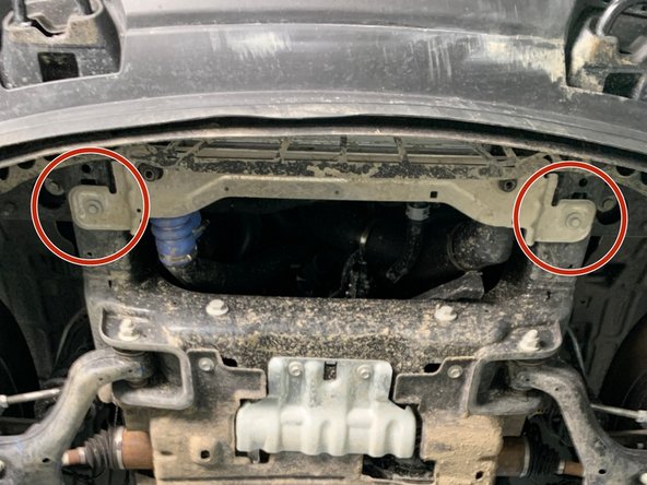 *If equipped* Using a 15mm wrench/socket, remove the two bolts securing the silver lower intercooler mount to the underside of the frame.