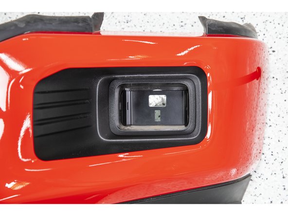 Insert two of the 5/16" carriage bolts through the side holes in the Grimm OffRoad fog light bracket and through the retaining clips in the bumper.